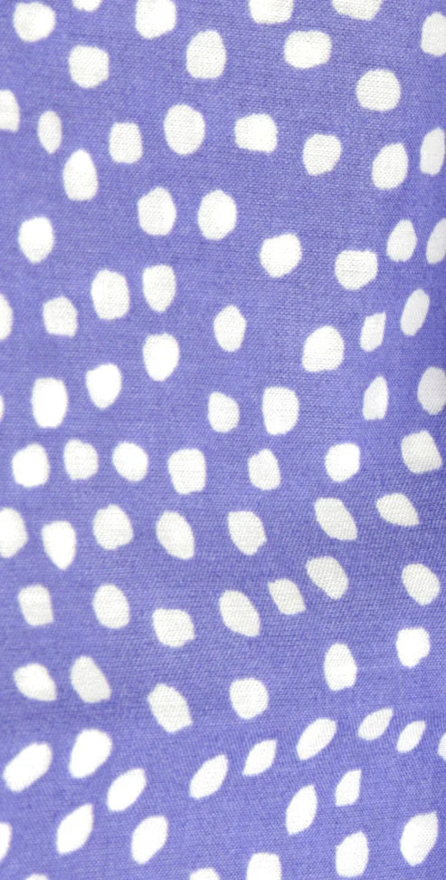 White polka dots on a purple background