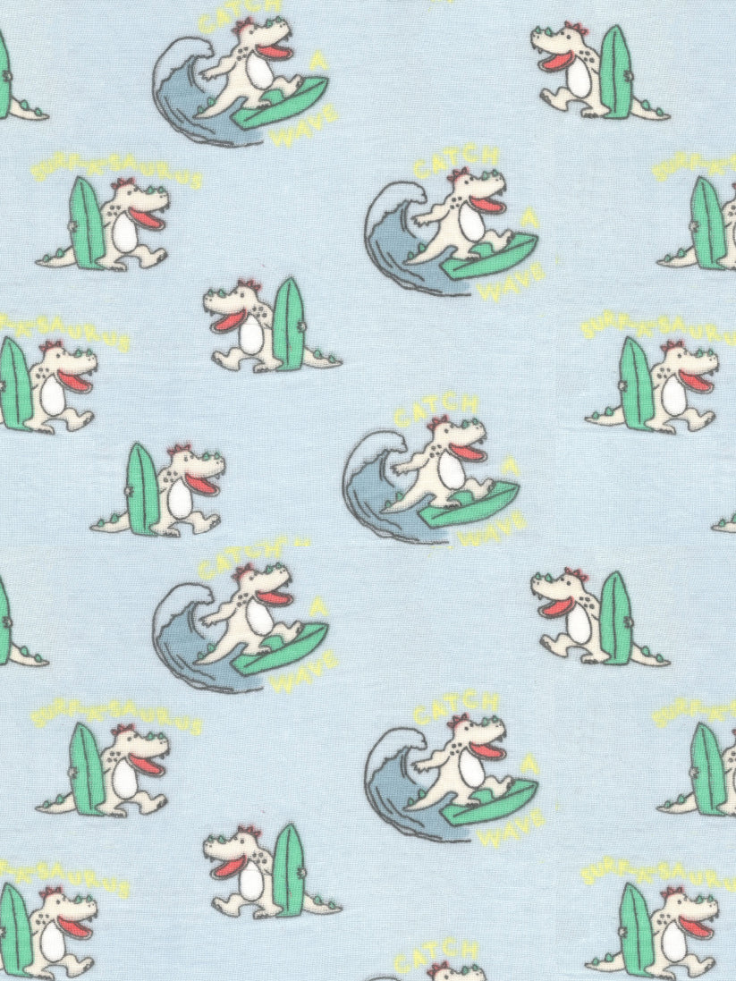 Pattern of cartoon dogs surfing on a light blue background