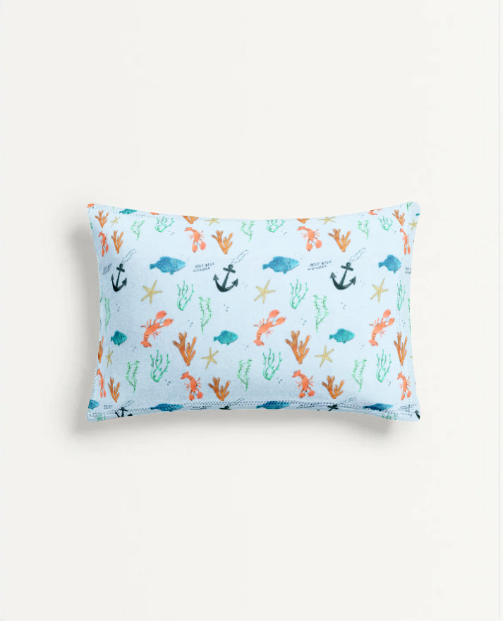 Rectangular pillow with ocean-themed pattern on a white background