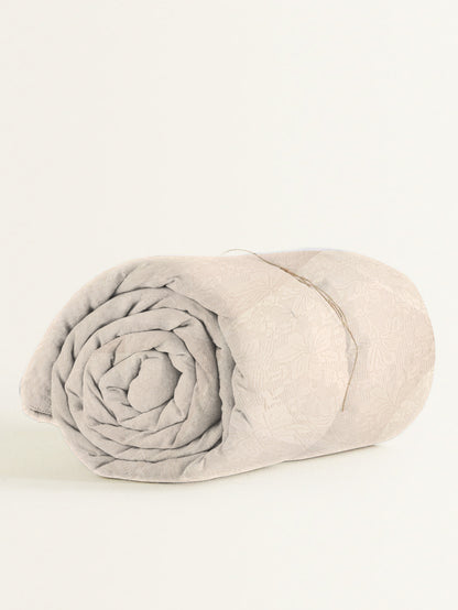 Rolled-up blanket on a white background
