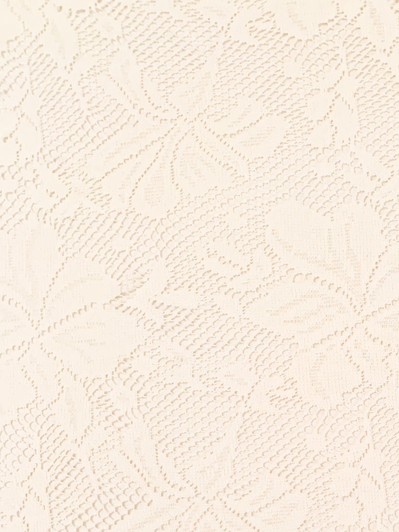 Close-up of a textured beige fabric with a subtle pattern