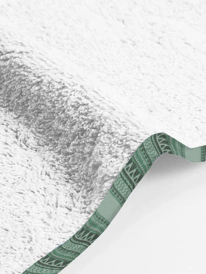 Close-up of a textured white surface with a green border