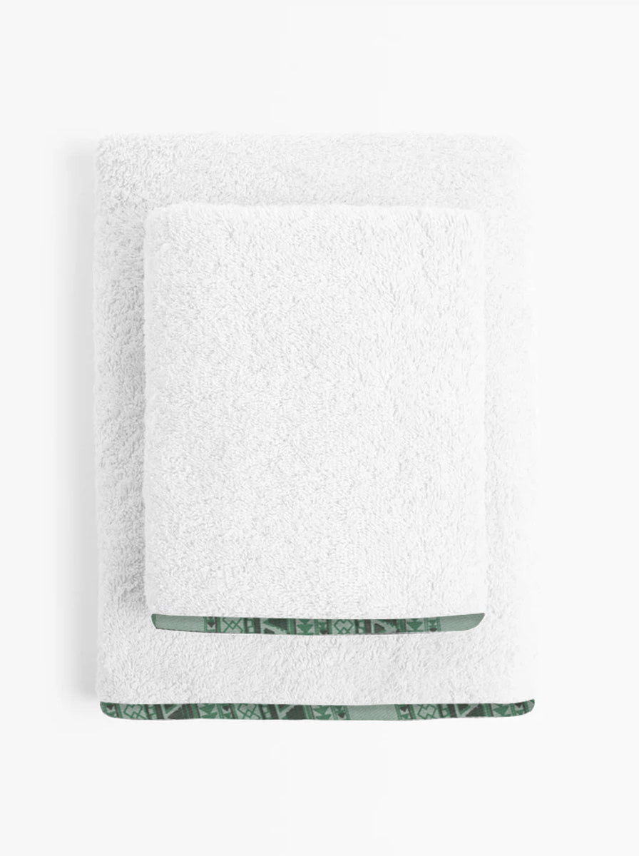 White towel with green trim on a white background