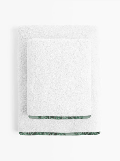 White towel with green trim on a white background