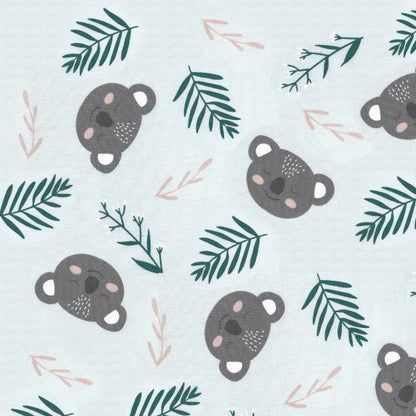 Pattern of bear faces and green leaves on a light blue background