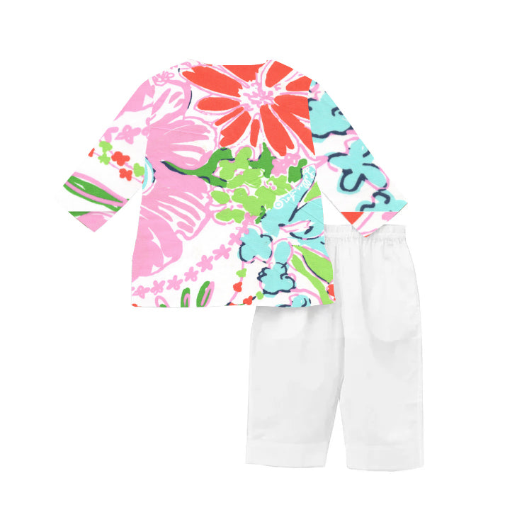 Colorful floral long-sleeve top and white pants on a white background